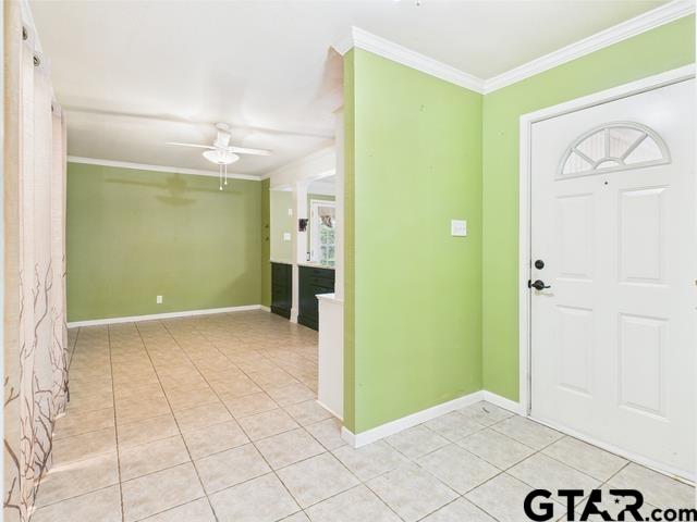 3323 S Keaton Ave, Tyler, TX 75701 - foyer with crown molding, baseboards, a ceiling fan, and light tile patterned flooring