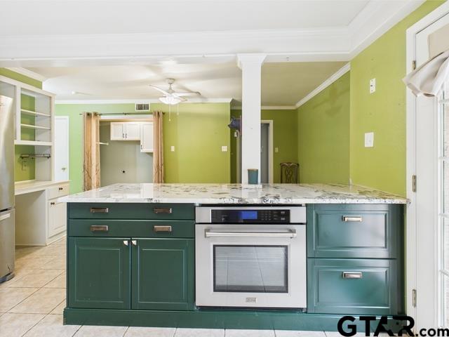 3323 S Keaton Ave, Tyler, TX 75701 - kitchen featuring ceiling fan, stainless steel appliances, ornate columns, ornamental molding, and green cabinets