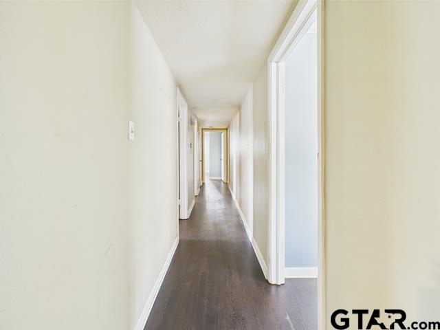 3323 S Keaton Ave, Tyler, TX 75701 - hall featuring baseboards and dark wood-style floors