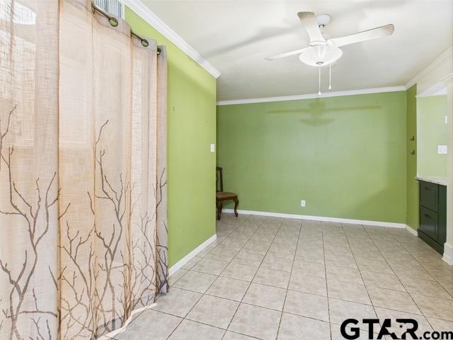3323 S Keaton Ave, Tyler, TX 75701 - interior space featuring light tile patterned floors, baseboards, ceiling fan, and ornamental molding