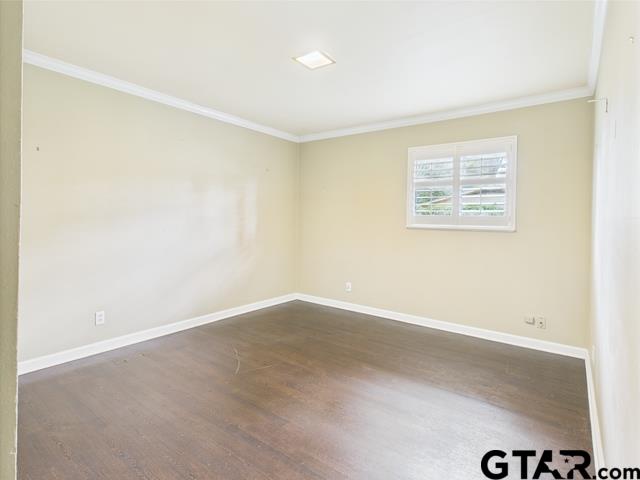 3323 S Keaton Ave, Tyler, TX 75701 - unfurnished room with baseboards, dark wood finished floors, and ornamental molding