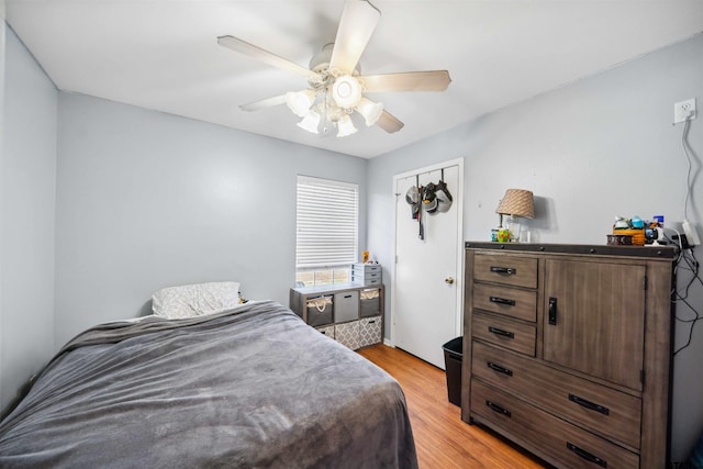 bedroom with light wood-style flooring and a ceiling fan