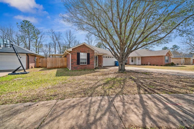 single story home with a front yard, fence, an attached garage, concrete driveway, and brick siding