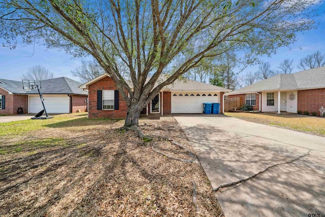 single story home featuring a garage, a front yard, brick siding, and driveway