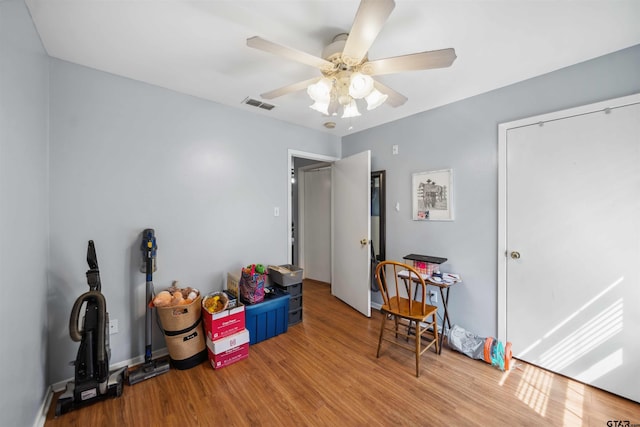 game room featuring visible vents, baseboards, wood finished floors, and a ceiling fan