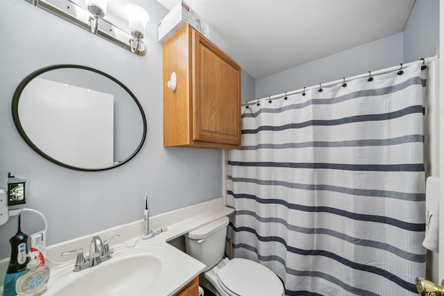 bathroom with vanity, a shower with shower curtain, and toilet