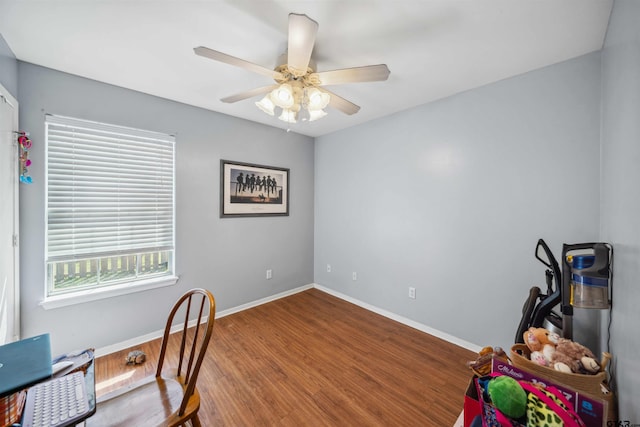 home office featuring a ceiling fan, wood finished floors, and baseboards