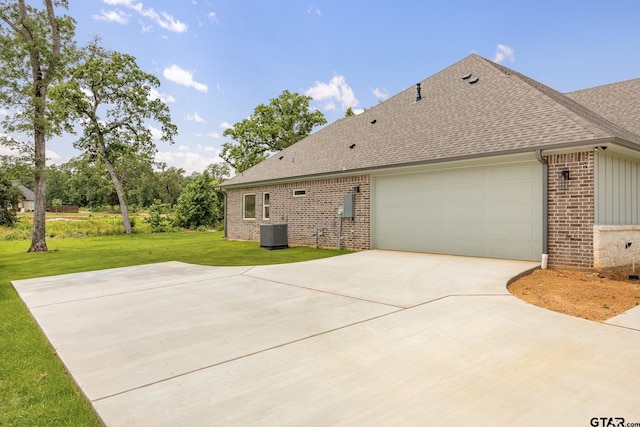 14524 Woodland Creek Dr, Tyler, TX 75706 - view of side of property with brick siding, central AC, roof with shingles, a lawn, and driveway