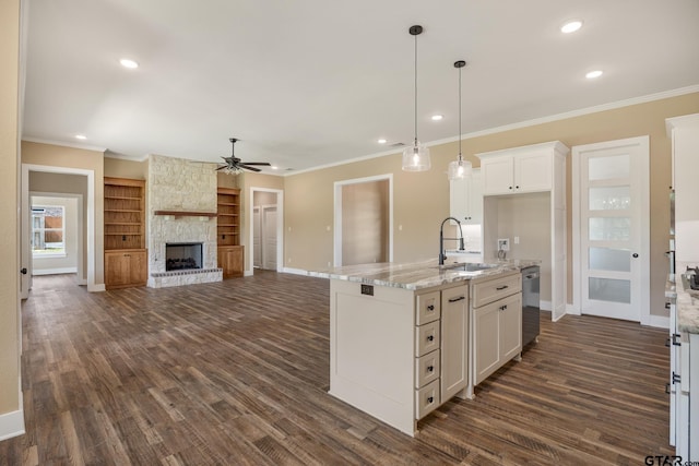 14524 Woodland Creek Dr, Tyler, TX 75706 - kitchen with a sink, baseboards, ceiling fan, white cabinetry, and crown molding