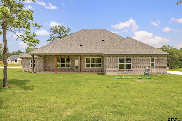 14524 Woodland Creek Dr, Tyler, TX 75706 - rear view of property with a shingled roof, a lawn, a patio, brick siding, and a ceiling fan