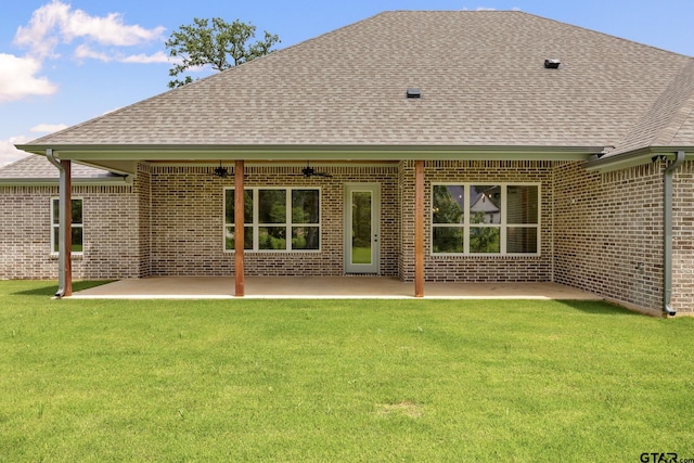 14524 Woodland Creek Dr, Tyler, TX 75706 - rear view of house featuring roof with shingles, brick siding, a ceiling fan, and a yard