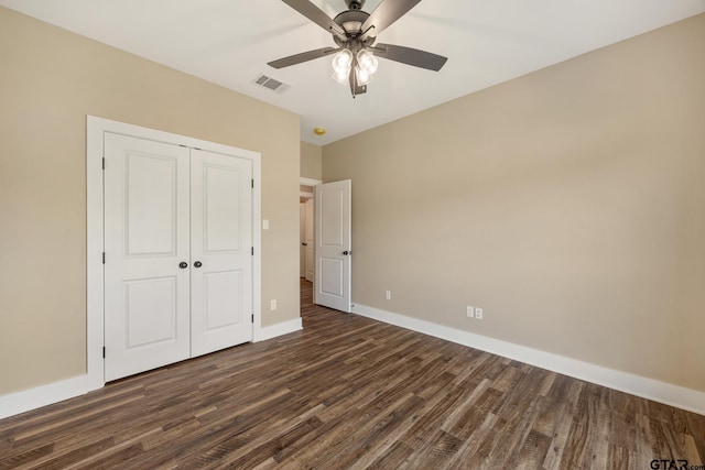 14524 Woodland Creek Dr, Tyler, TX 75706 - unfurnished bedroom featuring dark wood-style flooring, a closet, baseboards, and ceiling fan