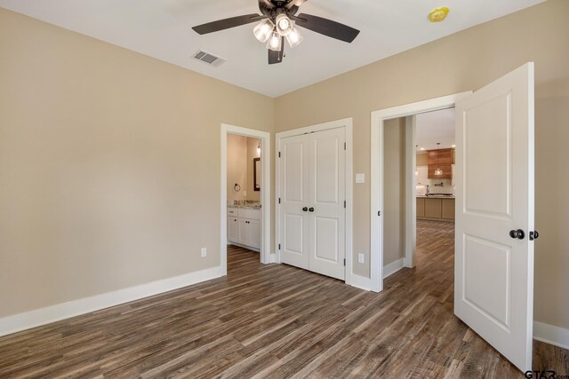 14524 Woodland Creek Dr, Tyler, TX 75706 - unfurnished bedroom featuring dark wood-style floors, a closet, baseboards, ensuite bath, and ceiling fan