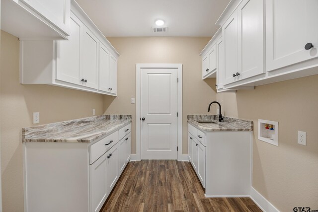 14524 Woodland Creek Dr, Tyler, TX 75706 - clothes washing area featuring hookup for a washing machine, cabinet space, dark wood-style flooring, and baseboards
