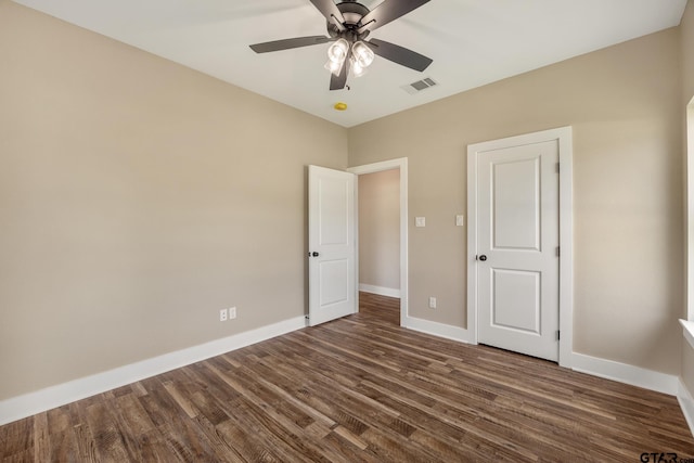 14524 Woodland Creek Dr, Tyler, TX 75706 - unfurnished bedroom with dark wood finished floors, baseboards, and ceiling fan