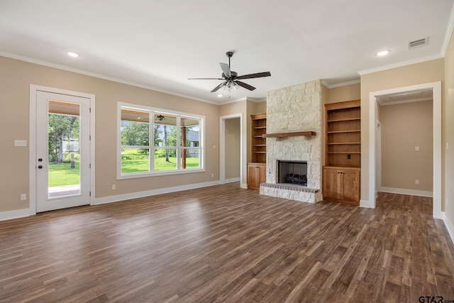 14524 Woodland Creek Dr, Tyler, TX 75706 - unfurnished living room with dark wood-style floors, a stone fireplace, ornamental molding, baseboards, and recessed lighting