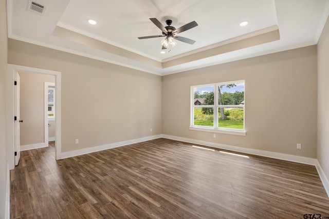 14524 Woodland Creek Dr, Tyler, TX 75706 - empty room with a tray ceiling, dark wood finished floors, crown molding, a ceiling fan, and baseboards