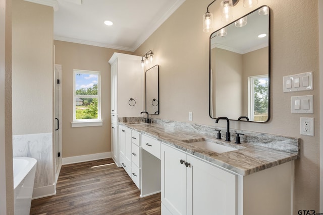 14524 Woodland Creek Dr, Tyler, TX 75706 - full bathroom with ornamental molding, wood finished floors, baseboards, a soaking tub, and double vanity