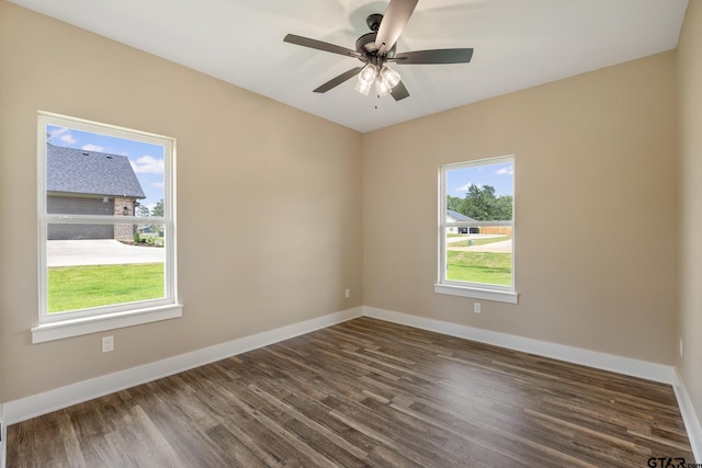 14524 Woodland Creek Dr, Tyler, TX 75706 - spare room featuring dark wood-type flooring, baseboards, and ceiling fan