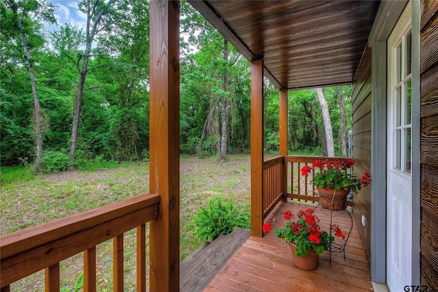 313 County Road 1442, Sulphur Springs, TX 75482 - deck featuring a view of trees and covered porch
