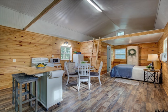 313 County Road 1442, Sulphur Springs, TX 75482 - bedroom with wood walls, vaulted ceiling, wood finished floors, and freestanding refrigerator
