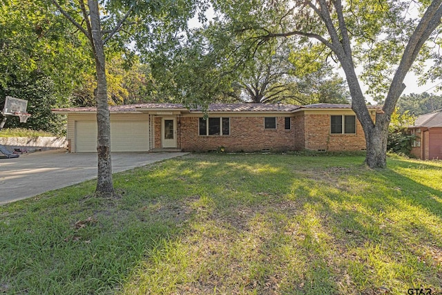 ranch-style house featuring a garage and a front lawn