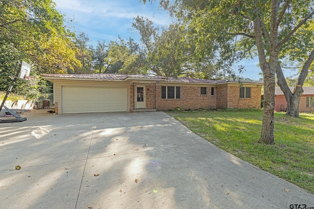 single story home featuring a garage and a front yard