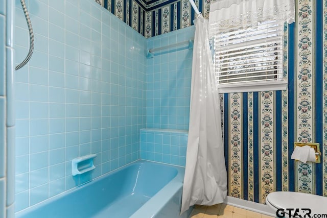 bathroom featuring toilet, tile patterned floors, and shower / bathtub combination with curtain