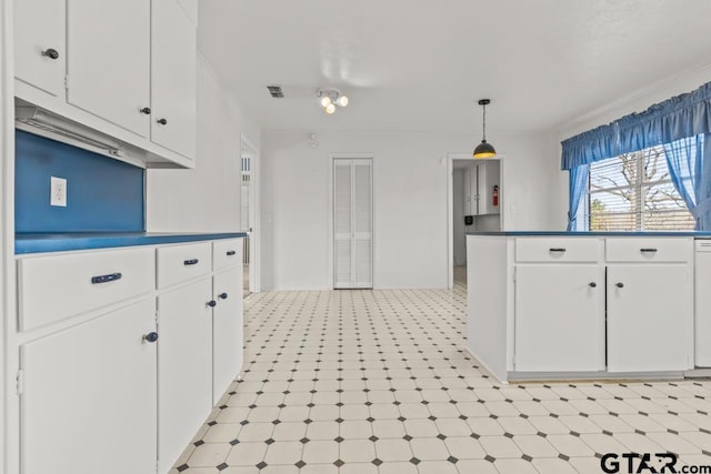 kitchen with white cabinets, decorative light fixtures, and dishwasher