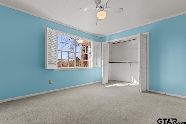 unfurnished bedroom featuring a closet, ceiling fan, light colored carpet, and ornamental molding