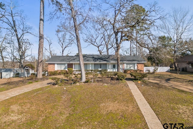 ranch-style home with a front lawn