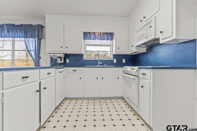 kitchen featuring sink, white appliances, white cabinets, and ornamental molding