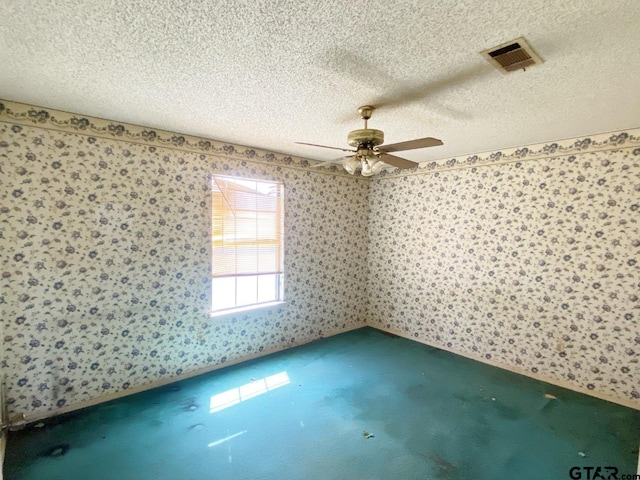 empty room featuring visible vents, a textured ceiling, carpet flooring, and wallpapered walls