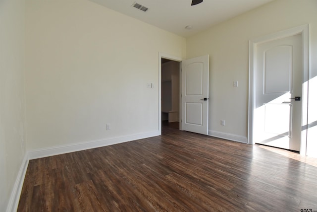 empty room featuring ceiling fan and dark hardwood / wood-style flooring