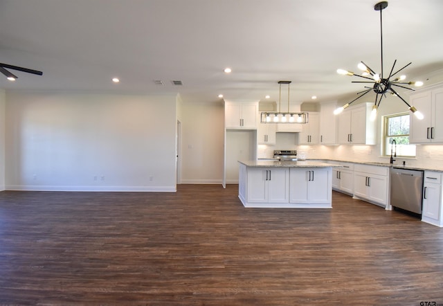 kitchen with white cabinets, appliances with stainless steel finishes, and a kitchen island