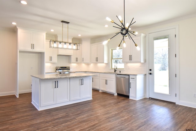 kitchen featuring stainless steel appliances, white cabinetry, and a kitchen island