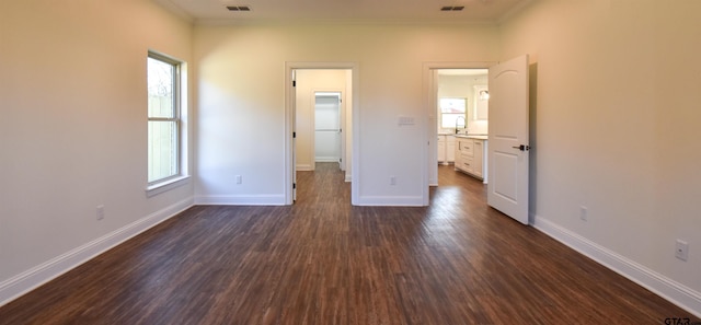 unfurnished bedroom with dark hardwood / wood-style floors and ornamental molding