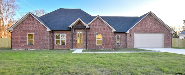 view of front of house featuring a garage and a front lawn