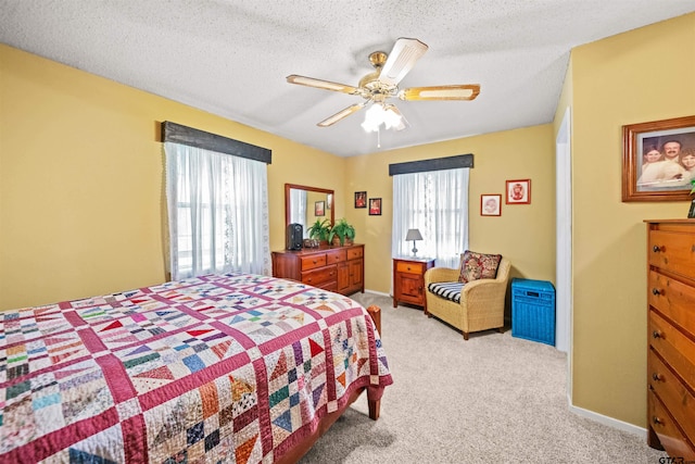 carpeted bedroom with a textured ceiling and ceiling fan