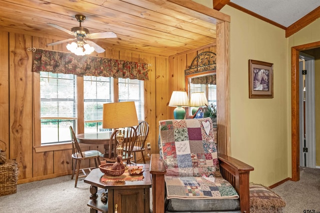 sitting room with wood walls, carpet flooring, and lofted ceiling