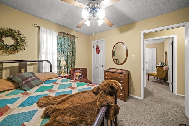 carpeted bedroom featuring a textured ceiling and ceiling fan