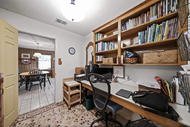 tiled office featuring a textured ceiling