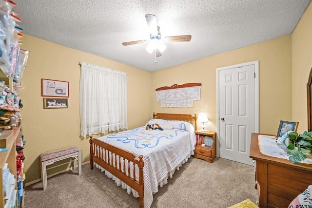 carpeted bedroom with ceiling fan and a textured ceiling