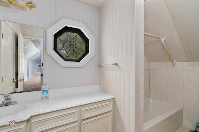 bathroom featuring vanity and tiled shower / bath