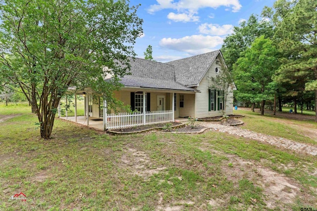 rear view of house featuring a lawn, a patio, and a porch