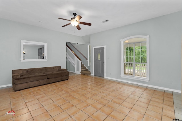 unfurnished living room with light tile patterned floors and ceiling fan