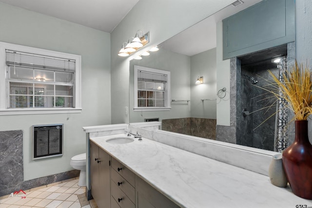 bathroom with vanity, tile patterned flooring, heating unit, and toilet