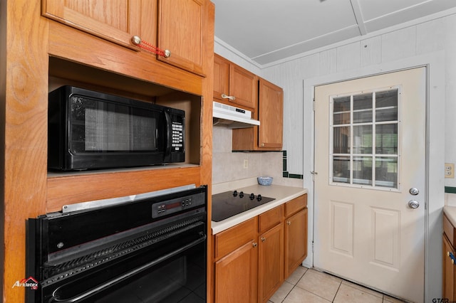 kitchen featuring light tile patterned floors and black appliances