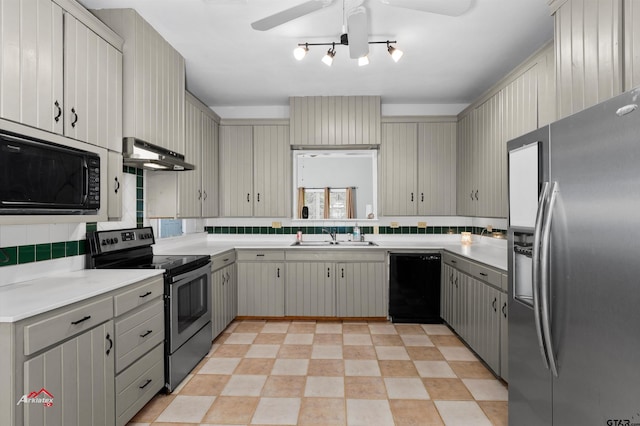 kitchen with sink, black appliances, gray cabinets, decorative backsplash, and exhaust hood