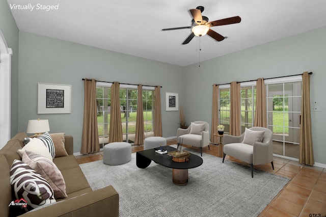 tiled living room featuring a healthy amount of sunlight and ceiling fan